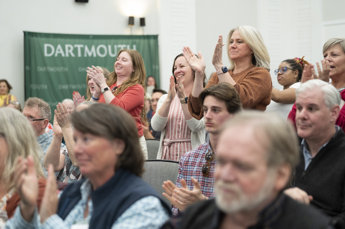 People standing and clapping